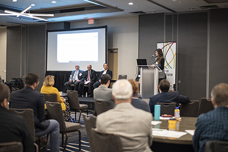 Emily Richards (podium) with (from left) Mark Berndt, Dan Murray, and Jeffrey Meek