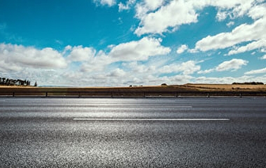 Paved road with blue sky overhead