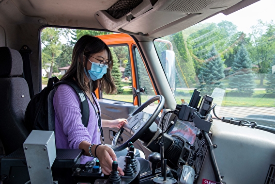 Camper sitting in the cab of a MnDOT vehicle