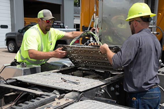 Local agency staff working on a large truck