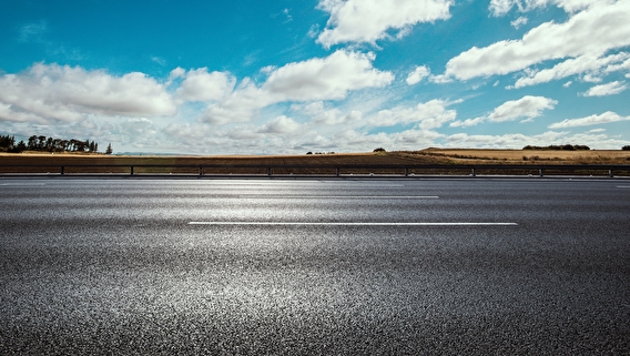 Smooth paved road with blue sky overhead