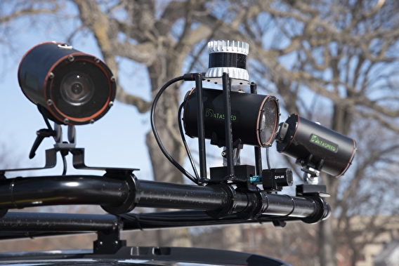 Cameras and sensors mounted to the roof rack of the MnCAV vehicle