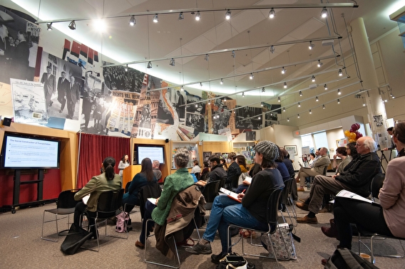 Attendees watching a presentation at the Our Transportation, Our Lives event