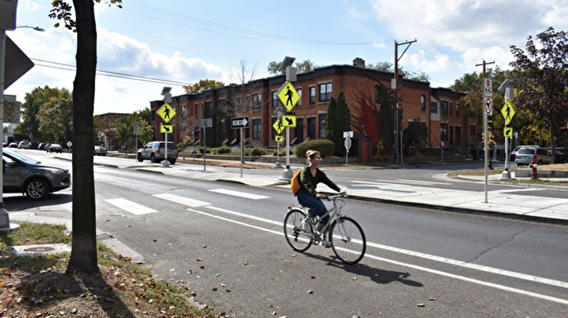 Bicyclist riding on a paved roadway