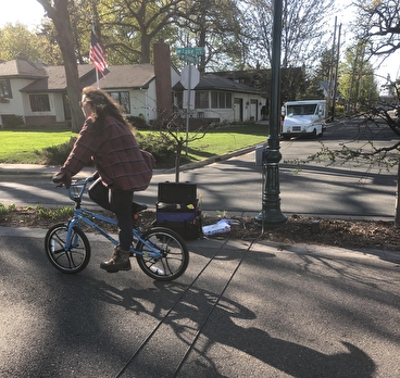 Bicyclist on a trail riding over a counting tube