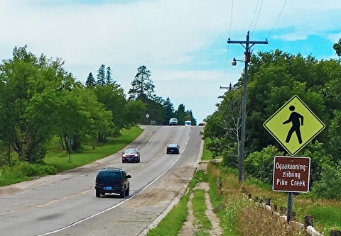 Pedestrian crossing sign at Pike Creek on tribal road